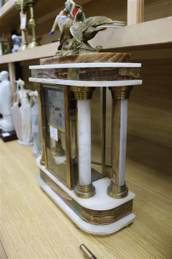 A 1930s polychrome onyx portico mantel clock, height 53cm